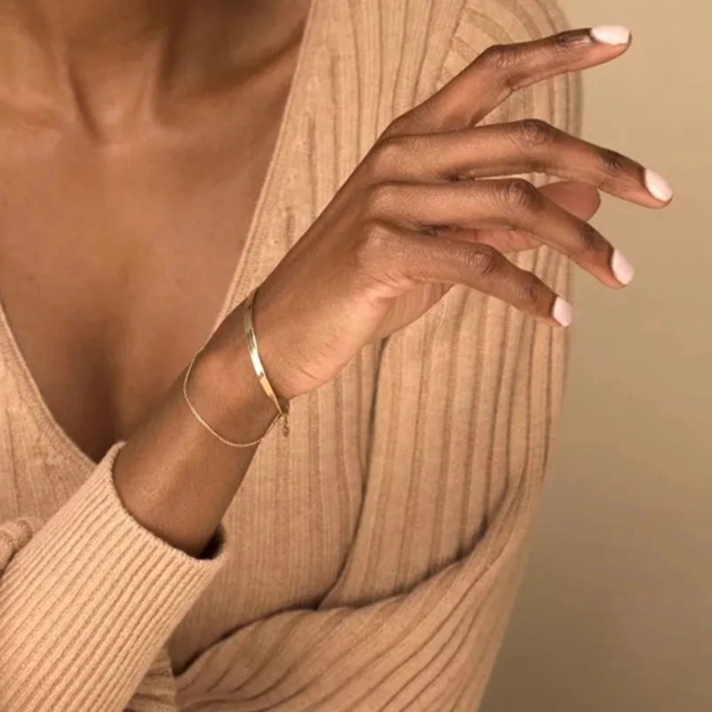 Woman wearing the Orion Bracelet in gold, showcasing its delicate and stylish design, perfect for everyday elegance or special occasions.