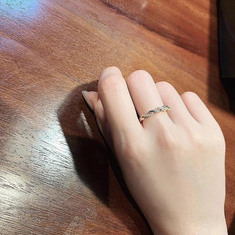 Seraphine Ring worn on a woman's hand, highlighting its elegant gold twisted design with crystals, ideal for casual or formal wear.