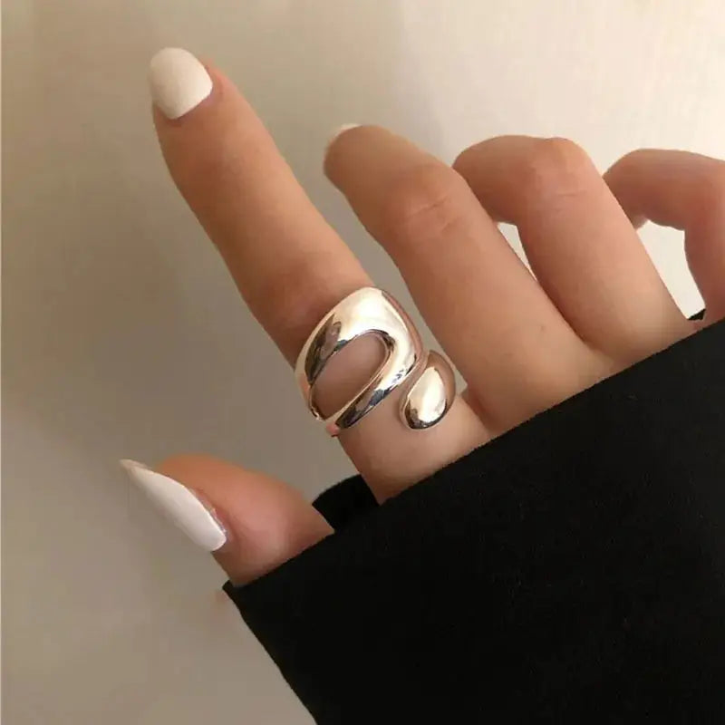 Lyra Ring in 925 sterling silver worn on a finger, highlighting its bold, minimalist design and shiny finish.