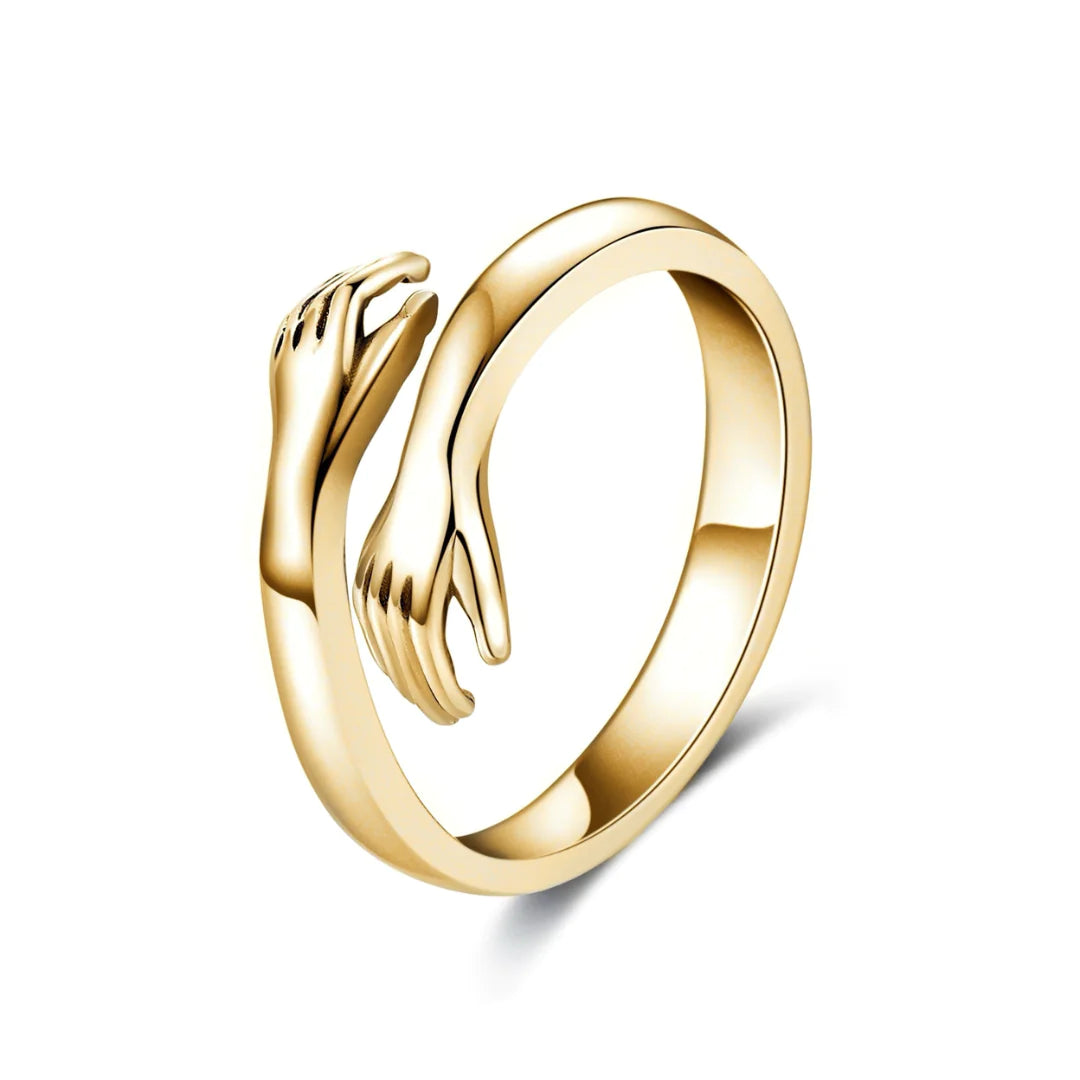 Gold Hug Ring featuring two hands elegantly embracing, symbolizing love and connection. A timeless jewelry piece for gifting or daily wear.