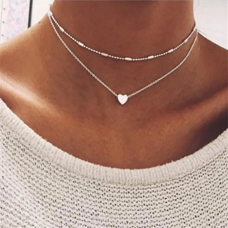 Silver Fiora Heart Necklace worn on a model, highlighting its layered design and heart charm for a chic and versatile jewelry piece.