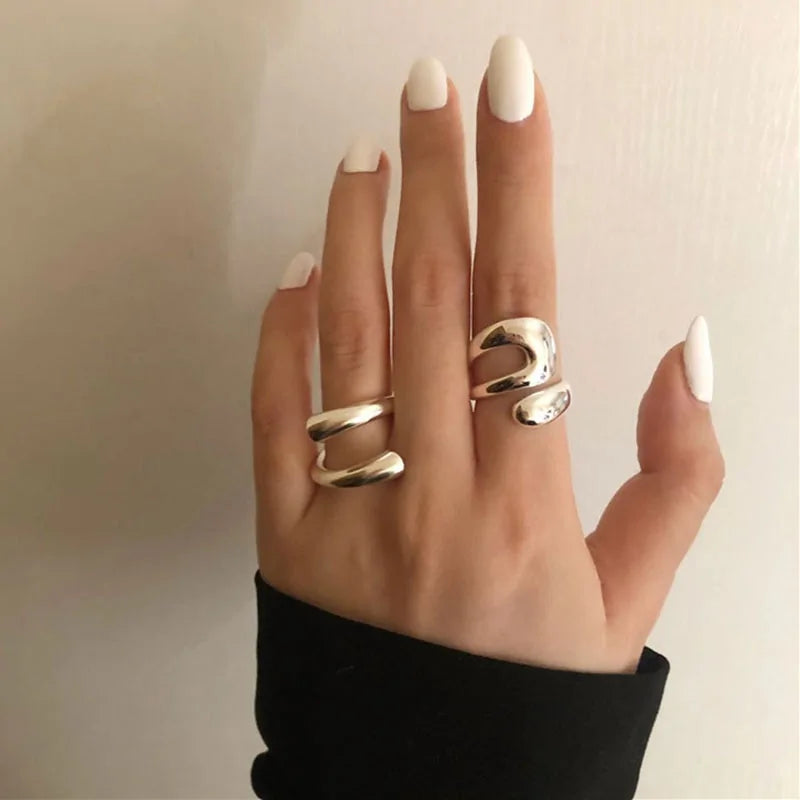 Two Lyra Rings in 925 sterling silver styled on a hand, showcasing their modern, minimalist aesthetic and polished look.
