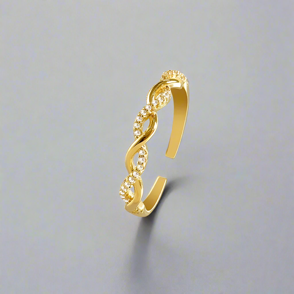 Seraphine Ring - Stylish adjustable open ring for women in gold with a twisted design and embedded crystals, perfect for elegant occasions.