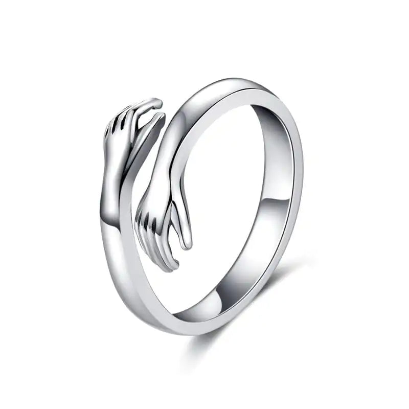 Silver Hug Ring with a delicate design of two hands in an embrace, representing comfort and love. A versatile and meaningful accessory.