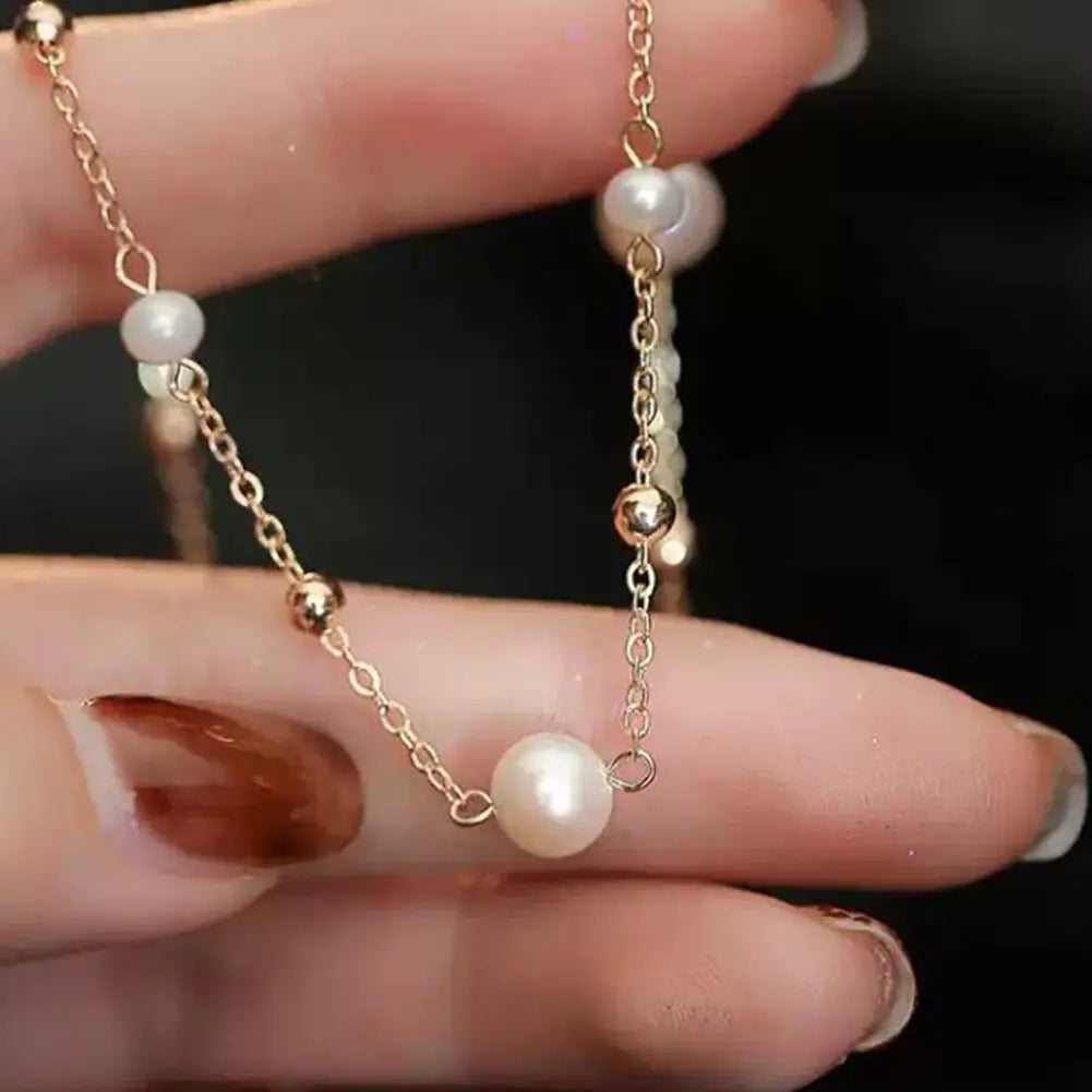 Close-up of the Luna Pearl Necklace highlighting the intricate gold chain and luminous pearls for a refined jewelry piece.