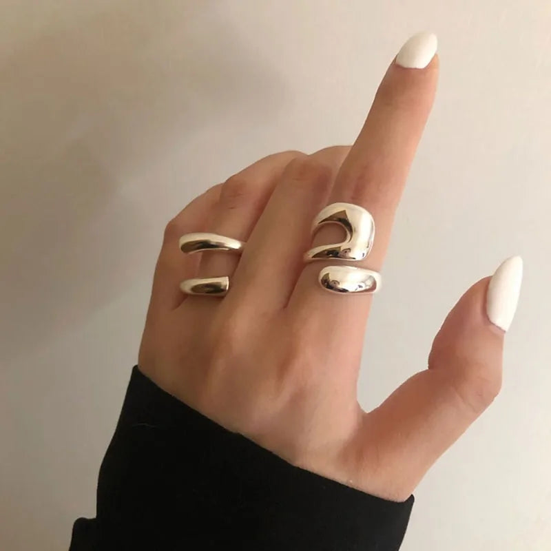 Close-up of two Lyra Rings in 925 sterling silver worn together, emphasizing their contemporary, sleek designs.